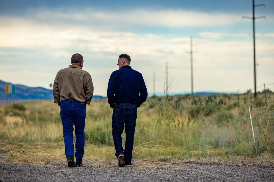 Two Nyquis team members walking together beside utility poles.