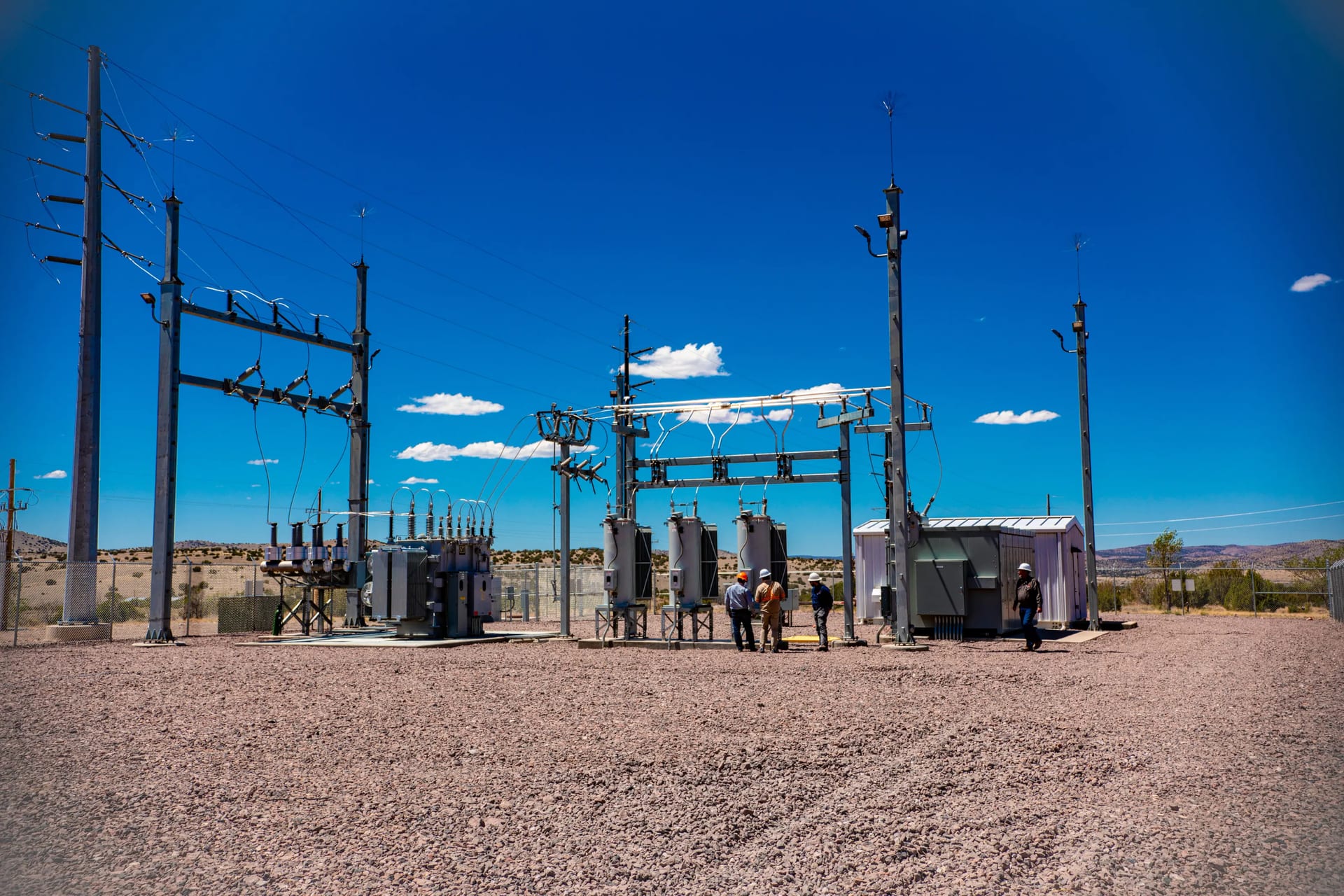 Crews at a Socorro substation under a clear blue New Mexico sky